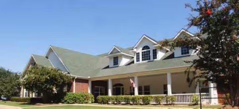Exterior view of Vickery Parke Assisted Living with a covered entrance and landscaped grounds.