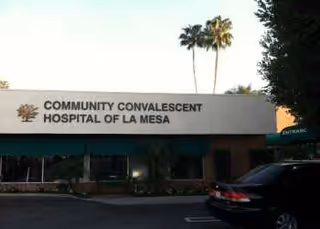 Front exterior of a care facility with a sign reading Community Convalescent Hospital of La Mesa.