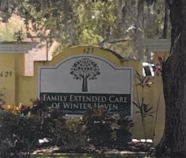 Outdoor view of a sign for Family Extended Care of Winter Haven, surrounded by greenery and trees, with the address number 625 visible on the sign structure.
