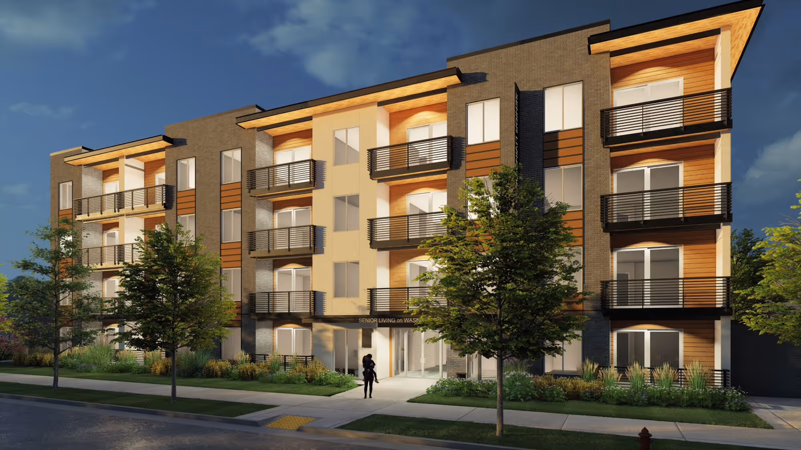 A four-story modern apartment building with balconies, landscaping, and two people at the entrance.