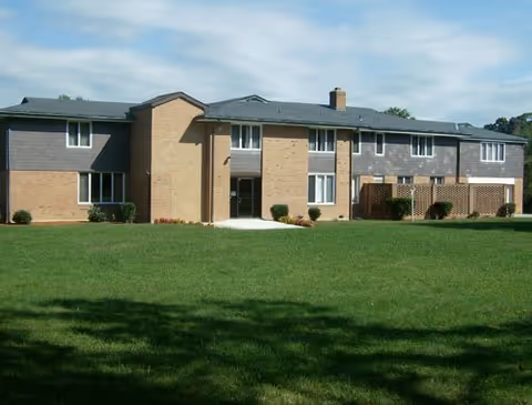 Exterior view of Henson Creek Assisted Living Facility with a green lawn.