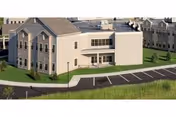 Exterior view of Vestal Park Rehabilitation and Nursing Center with parking lot and green lawn.