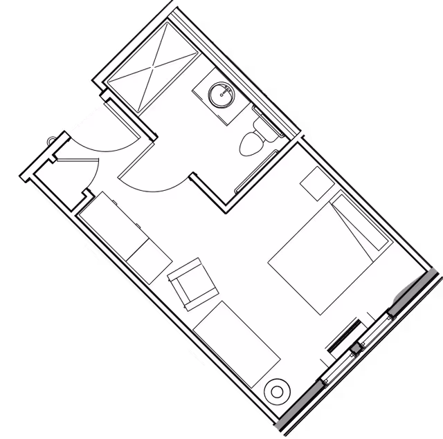 Architectural floor plan of a small residential unit featuring a bedroom with a bed, nightstand, and dresser, a living area with a sofa, chair, and table, and a bathroom with a shower, sink, and toilet.