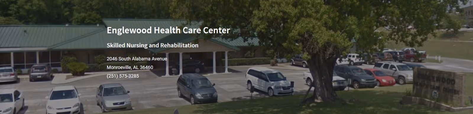 Exterior view of Englewood Health Care Center with vehicles parked outside.