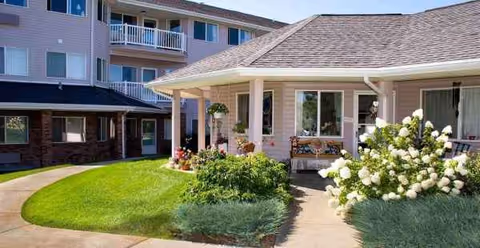 Exterior view of Holiday Aspen View facility with a covered entrance and landscaped front yard.