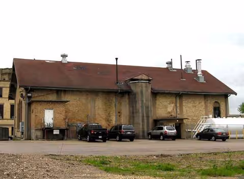Exterior view of Badger Prairie Health Care Center with parked cars outside.