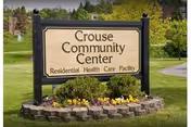 A sign reading Crouse Community Center sits on a landscaped lawn.