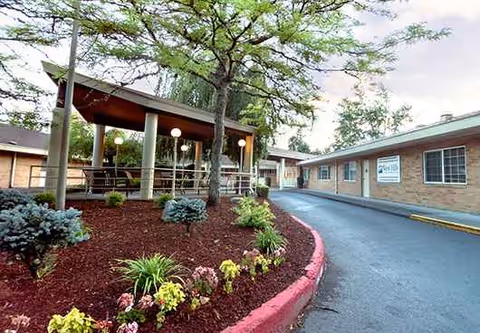 Exterior view of West Hills Health & Rehabilitation with a covered entrance and landscaped grounds.