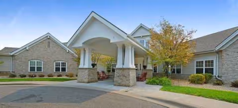 Exterior view of Brookdale Plymouth entrance with a covered porte-cochere and landscaping.