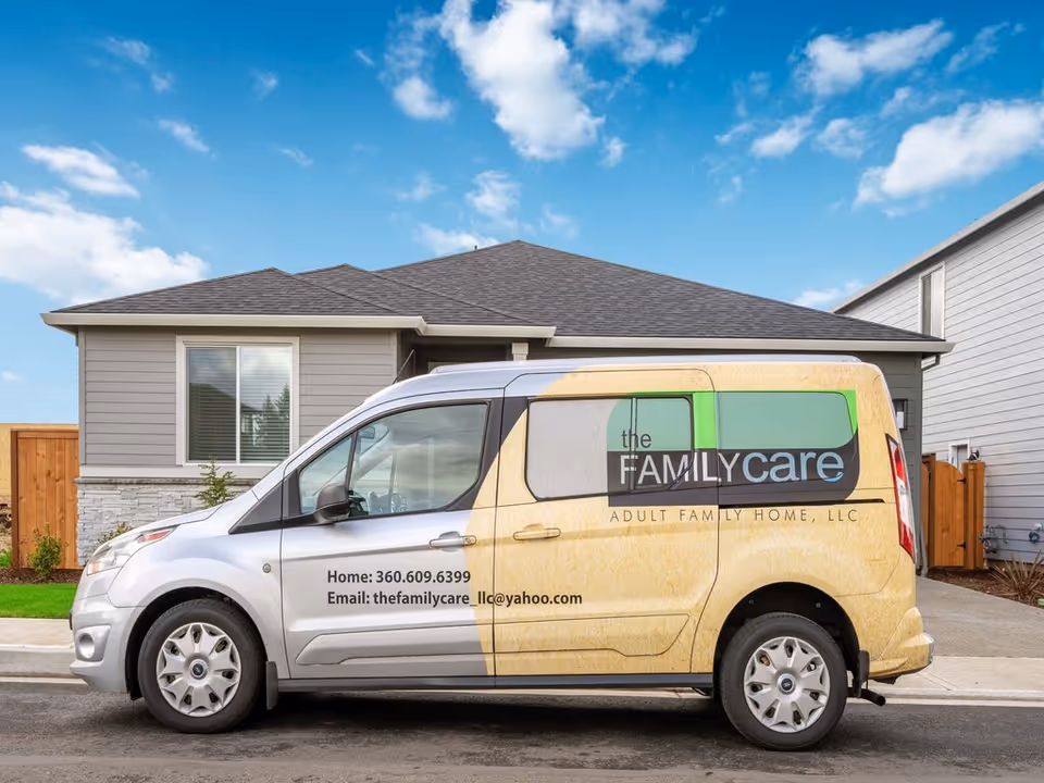 A branded 'The Family Care' van parked in front of a single-story suburban house.