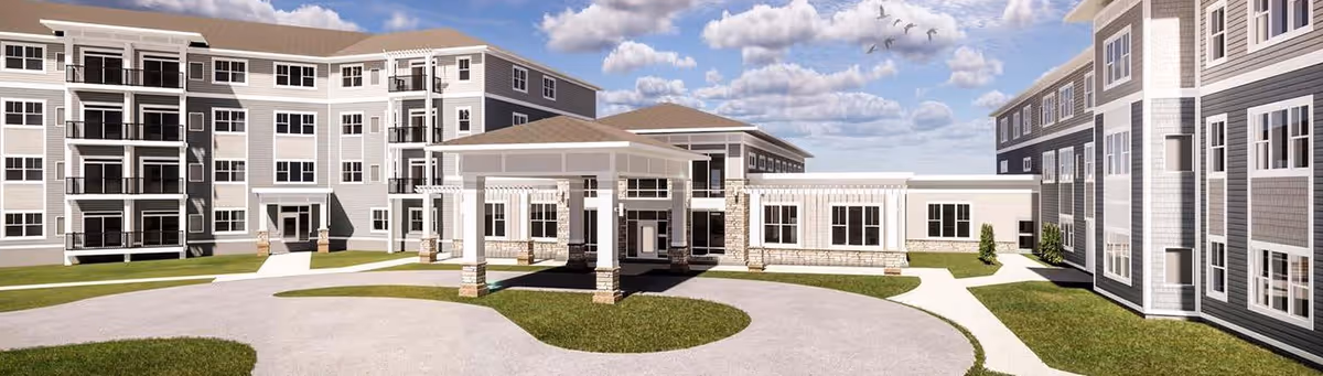 Front exterior of a multi-story senior living building with a covered entrance and circular driveway.