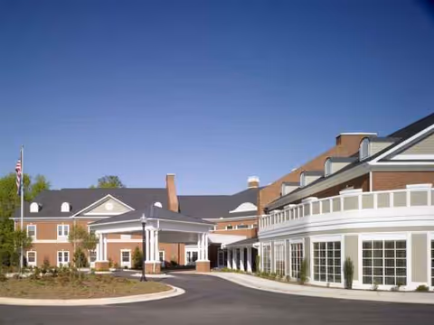 Exterior view of Arbor Terrace Crabapple with entrance and curved driveway.