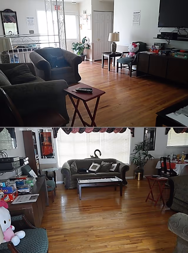 A bright living room with hardwood floors, upholstered sofas and chairs, small tables, a TV, and houseplants.