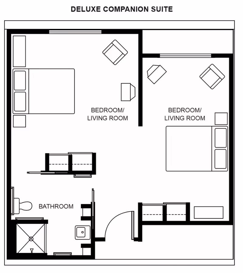 Floor plan of a deluxe companion suite showing two separate bedroom/living room areas, each with a bed, chairs, and small tables. There is a shared bathroom with a toilet, sink, and shower. The layout includes doors and windows.