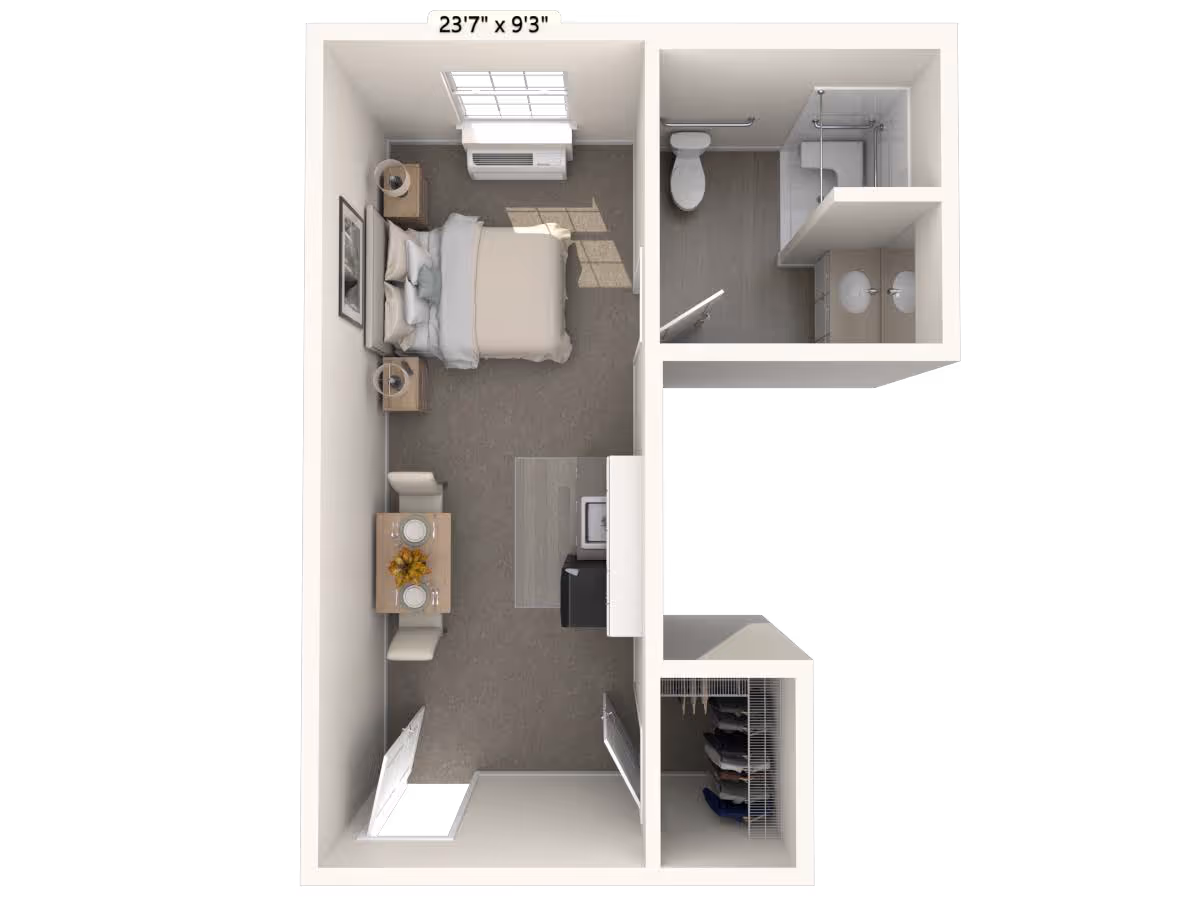 Top-down floor plan of a small studio apartment featuring a bedroom area with a bed, two nightstands, and a window with an air conditioning unit. Adjacent to the bedroom is a bathroom with a toilet, shower, and double sink vanity. The main living area includes a small dining table set for two and a kitchenette with a sink and refrigerator. There is also a closet near the entrance.