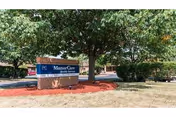 ManorCare sign in front of a brick building with trees and red mulch