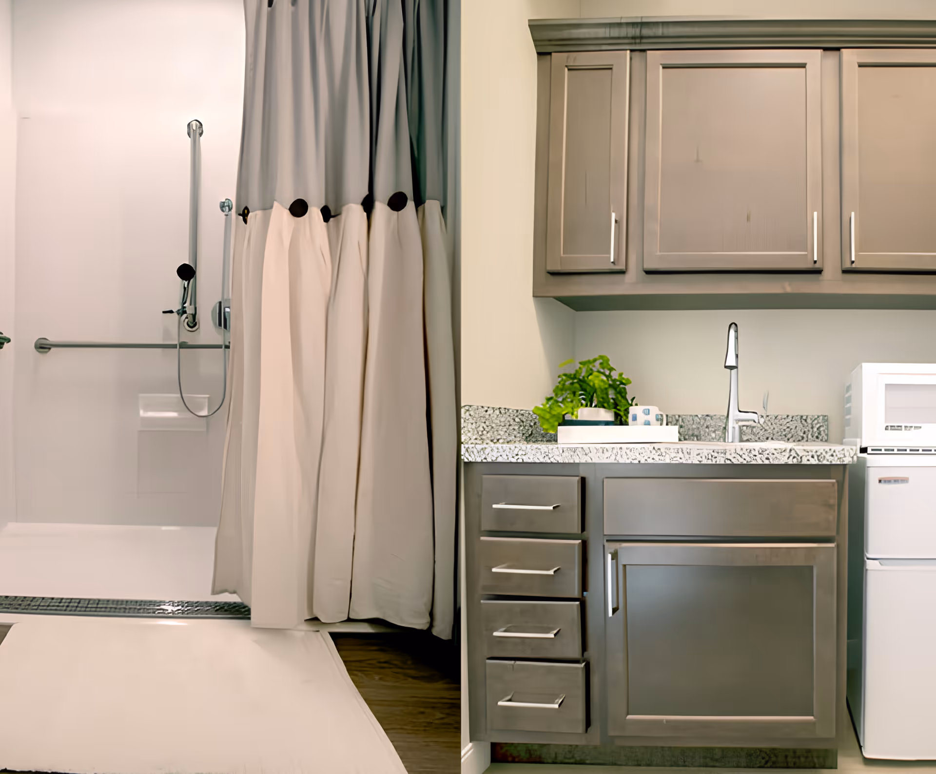 A bathroom area with a shower on the left side featuring a grab bar and a handheld showerhead with a curtain partially drawn. On the right side, there is a countertop with a sink, a faucet, a small potted plant, and a microwave on a small refrigerator underneath. Above the countertop are wooden cabinets.