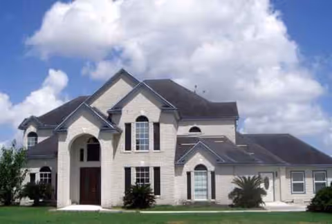 Exterior view of a two-story senior living facility with brick facade.