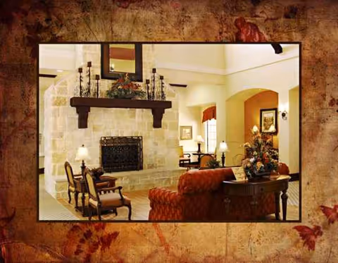 Cozy living room with fireplace, seating, and decorative lighting in a warm lobby.