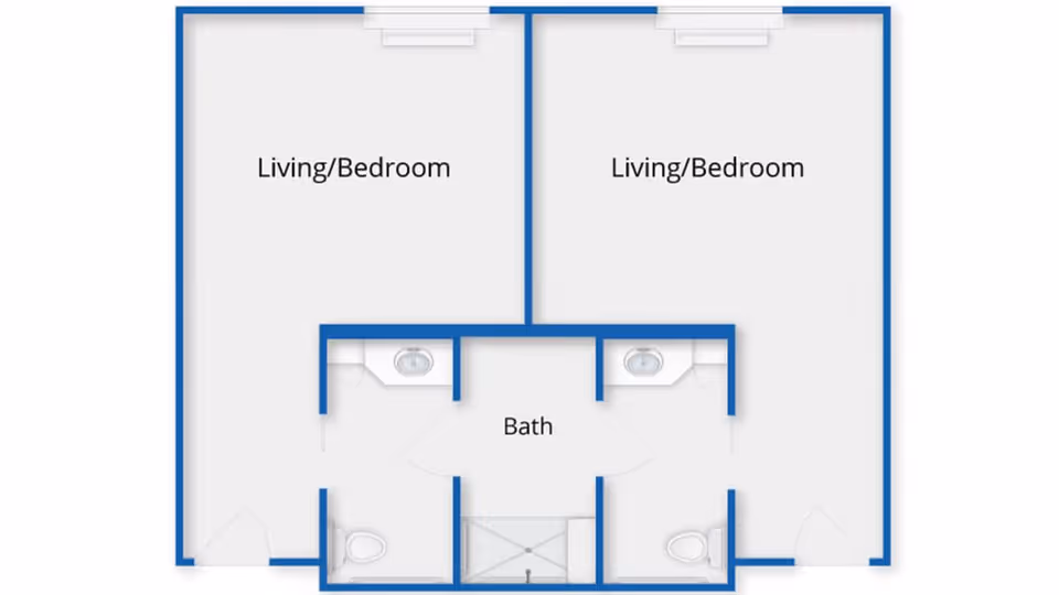 Floor plan showing two adjacent living/bedroom areas, each with a private bathroom containing a toilet and sink, and a shared central bath area with a shower.