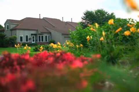 Medford Leas exterior building with colorful blurred flowers in foreground.