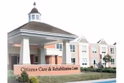 Exterior view of Citizens Care & Rehabilitation Center building with a covered entrance supported by white columns and a sign in front displaying the facility's name.