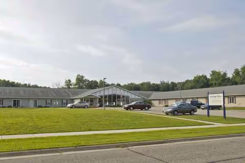 Exterior view of Heritage House of Portage Assisted Living with glass entry.