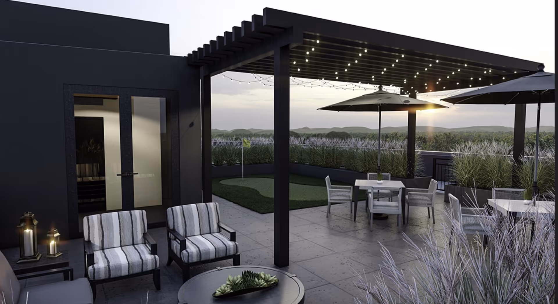 Rooftop patio with a pergola strung with lights, outdoor seating, umbrellas, and a small putting green at sunset.