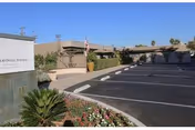 Exterior view of Somerset Subacute Rehab entrance with parking and landscaping.