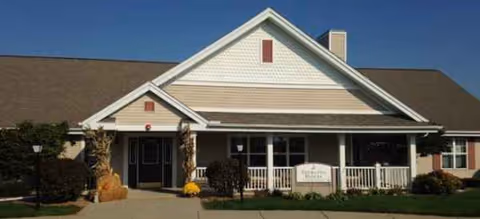 Front view of Brookdale Bay City facility entrance with porch and pumpkins