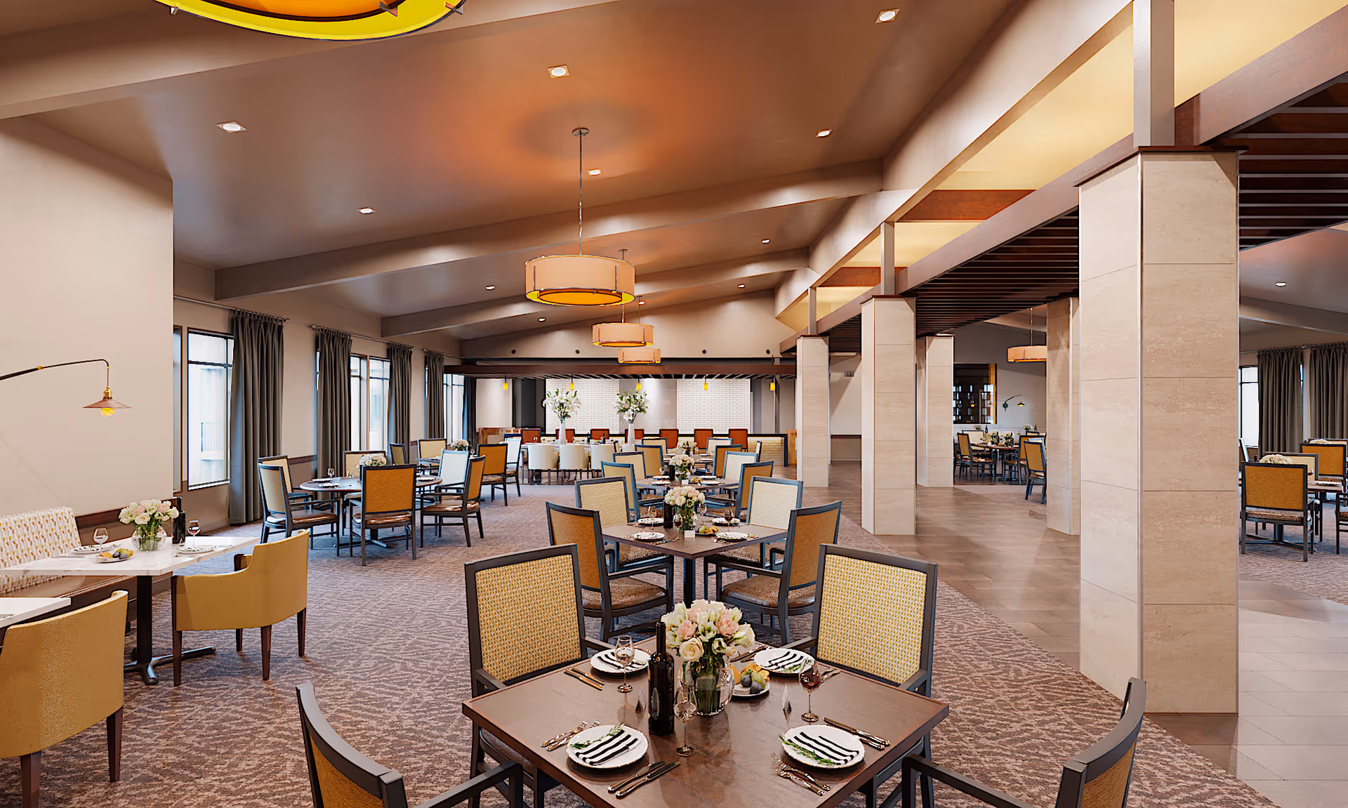 Spacious, well-lit dining room with multiple set tables and chairs, pendant lights, and decorative columns.