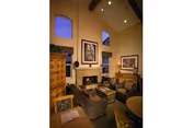 Cozy interior lounge at The Jasmine at Founders Village with fireplace and framed art.