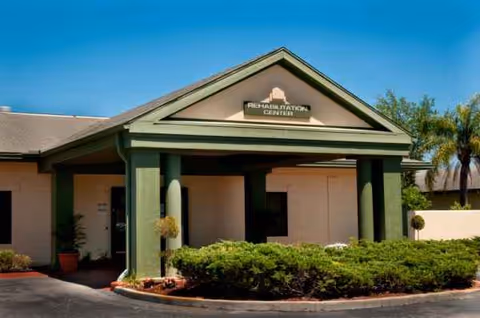 Front view of Solaris HealthCare Bayonet Point entrance with green columns and manicured shrubs.
