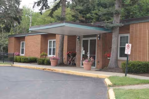 Entrance to Eden Rehabilitation and Nursing Center with brick exterior, canopy, and planters.