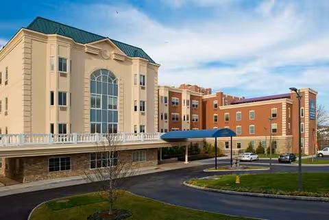Exterior view of The Bristal Assisted Living at White Plains with driveway and entrance