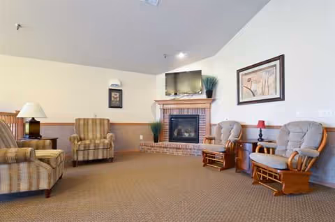Lounge in The Waterford at Plymouth I with fireplace and seating.