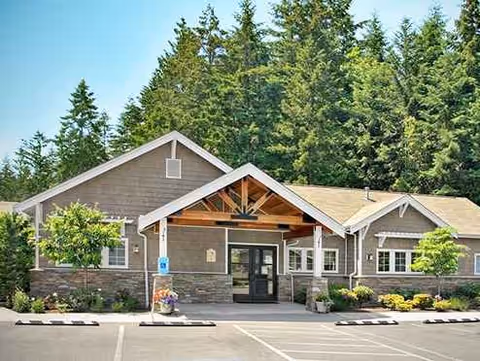 Front exterior view of The Cottages at Peach Creek entrance with parking.