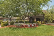 Front view of Life Care Center of Athens with green lawn, trees, and entrance.