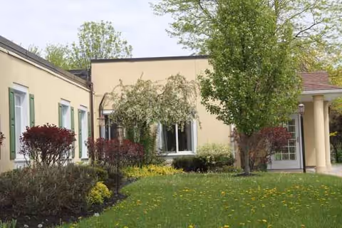 Exterior view of Absolut Care of Gasport with entrance and landscaped lawn.
