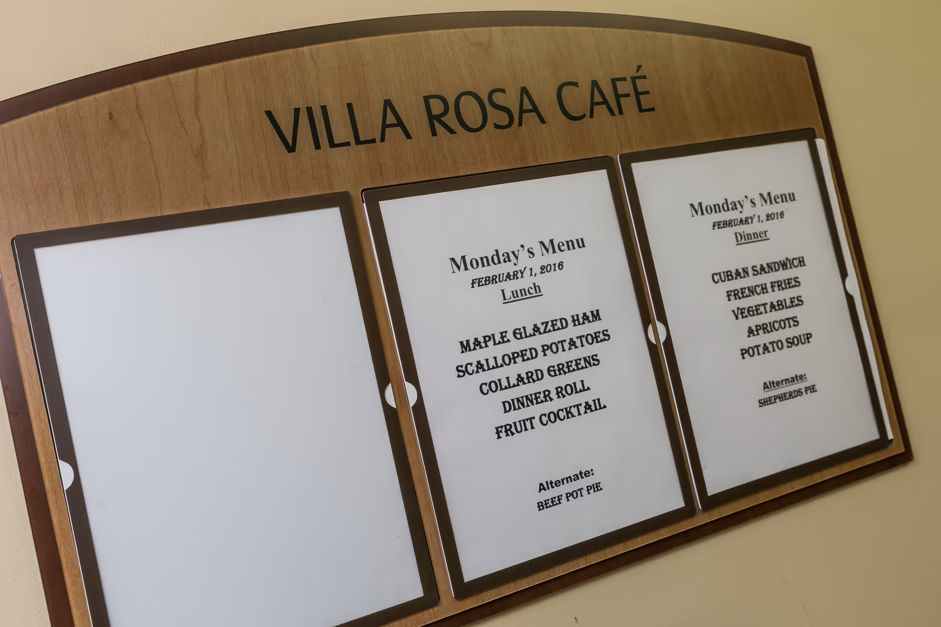 Wall-mounted Villa Rosa Café wooden menu board with two printed daily menus in frames.