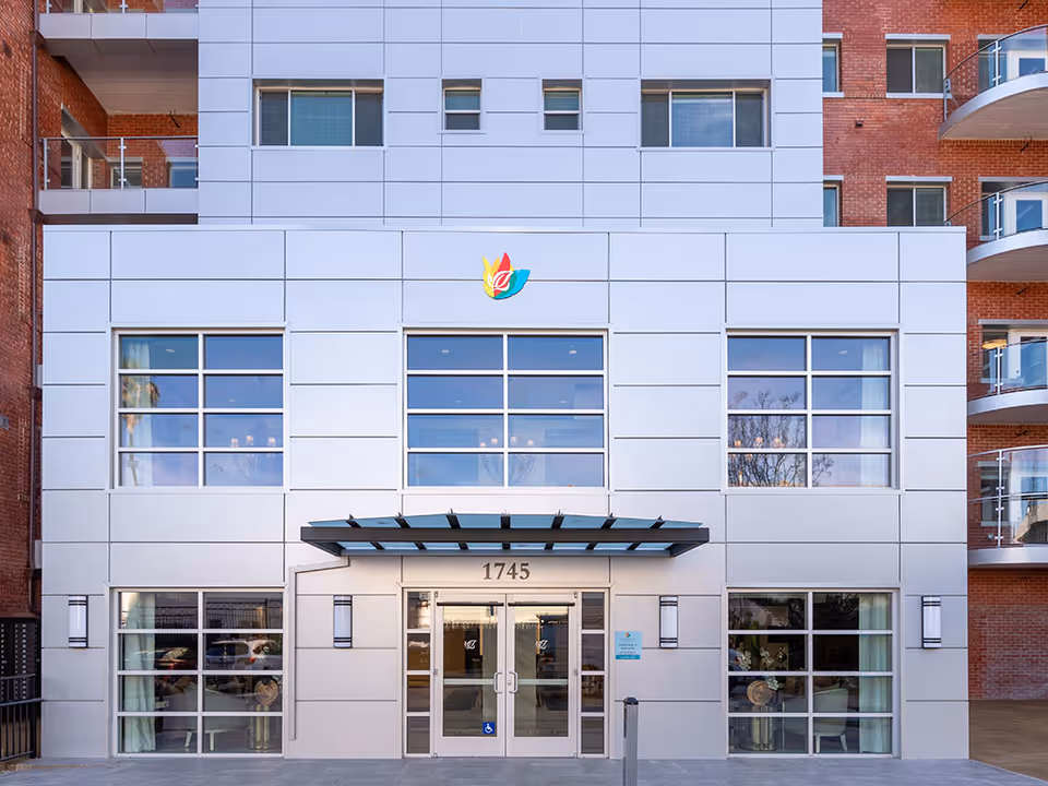 Street-level front entrance of Hollywood Hills Senior Living building at 1745 with large windows and a glass door.