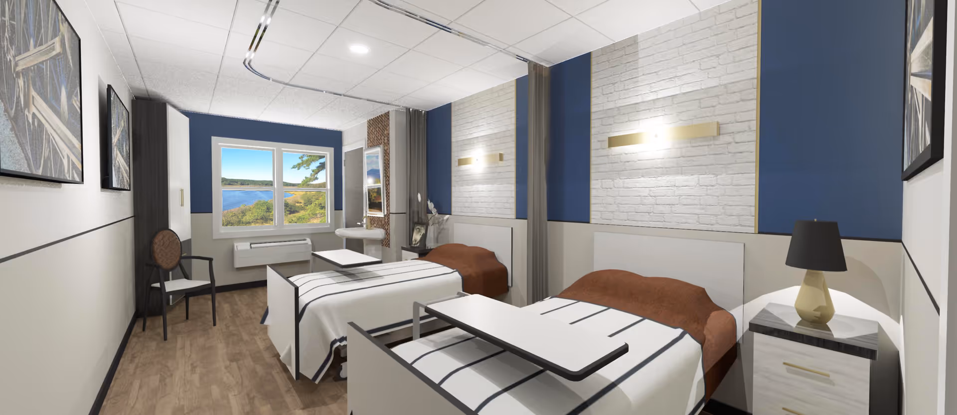 A bright and clean rehabilitation room with two hospital beds, each with a brown blanket and white striped sheets. Each bed has an adjustable overbed table. The room features a window with a scenic view of a lake and trees, blue accent walls with white brick panels, a nightstand with a lamp, and two chairs along the wall. The floor is wood, and there are framed pictures on the walls.