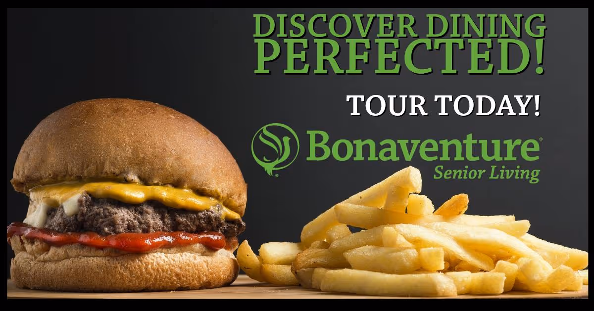 A cheeseburger with ketchup and mayonnaise on a bun next to a pile of French fries on a wooden surface with text promoting dining at Bonaventure Senior Living.