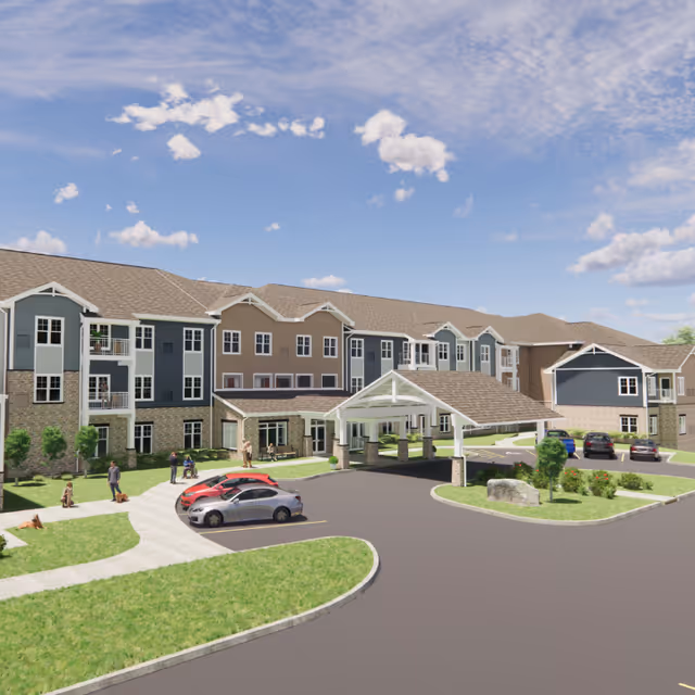 Front exterior of Meadowview of Clive senior living building with a covered porte-cochere, parked cars and landscaped grounds under a blue sky.