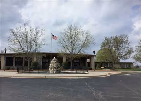 Exterior front view of Tablerock Healthcare with flagpole, stone centerpiece, and entrance.