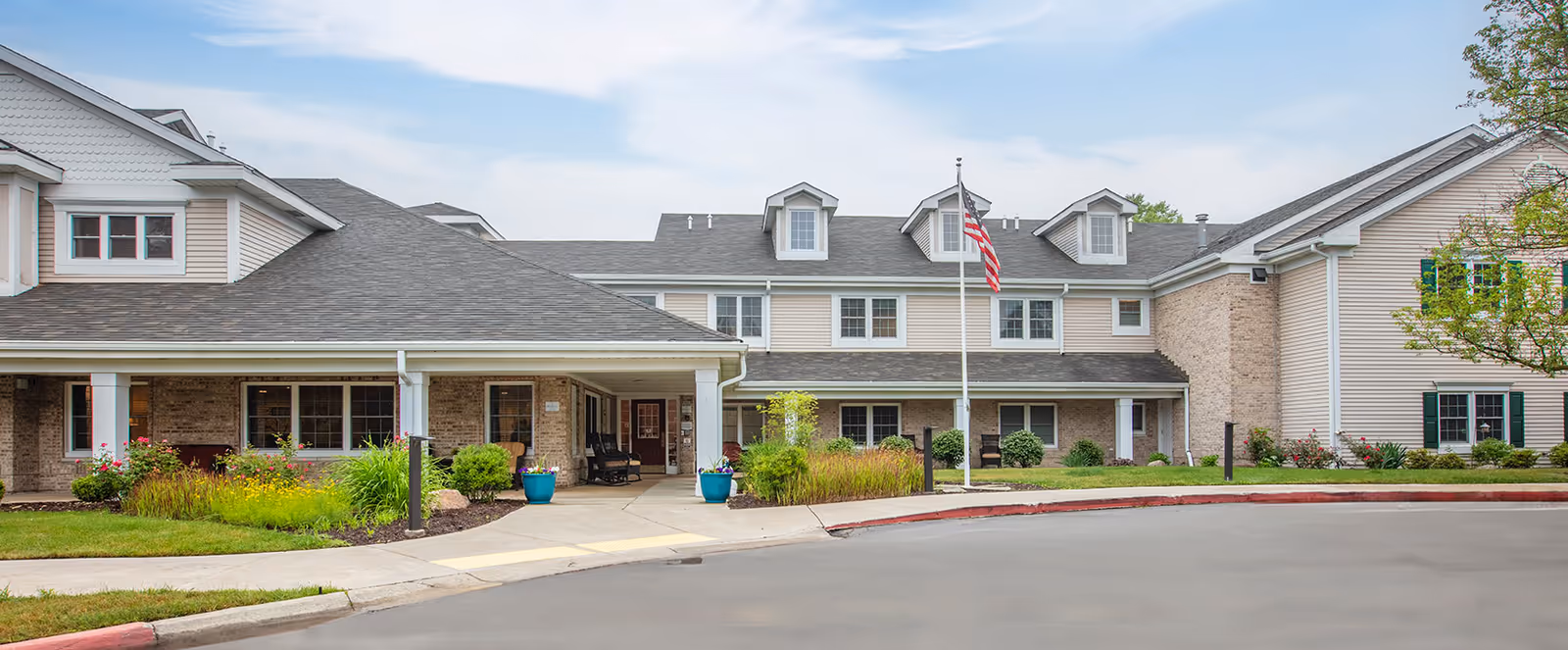 Brookdale Meridian Assisted Living exterior with front entrance, flagpole, and landscaped grounds.