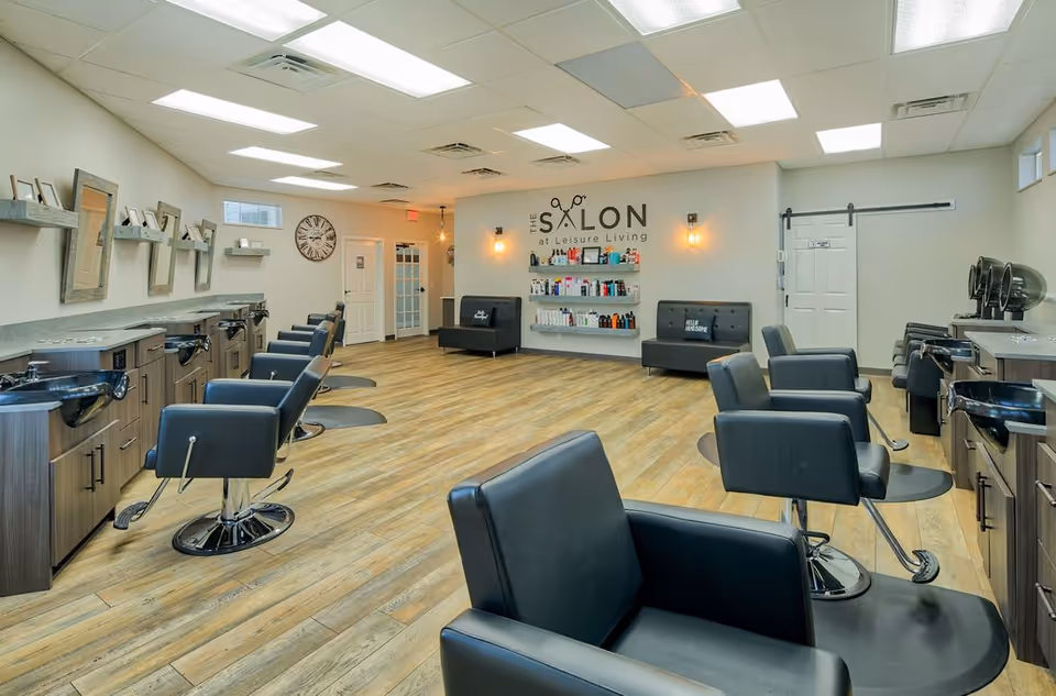 Interior salon at Leisure Living with styling chairs, sinks, and product shelves.