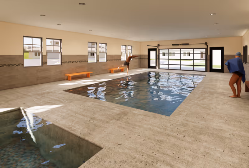 Indoor swimming pool and adjacent hot tub in a bright pool room with benches, windows, and two people nearby.