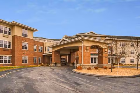 Exterior view of Trustwell Living at Eagle Pointe Place showing the building entrance and drive