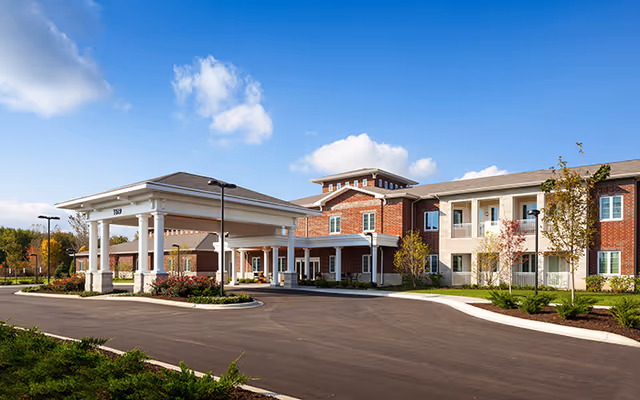 Exterior view of HarborChase of Naperville with a covered entrance and parking lot